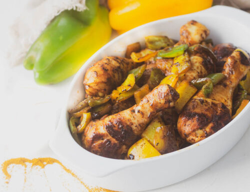 Spiced  chicken with peppers in a pan