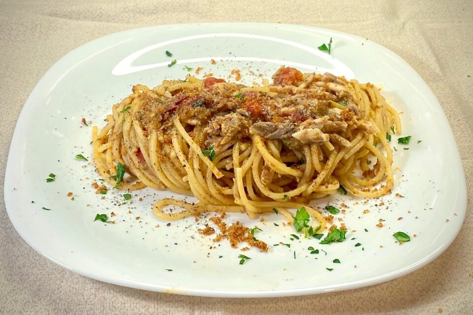 Spaghetti with fresh anchovies tomatoes and crumbs