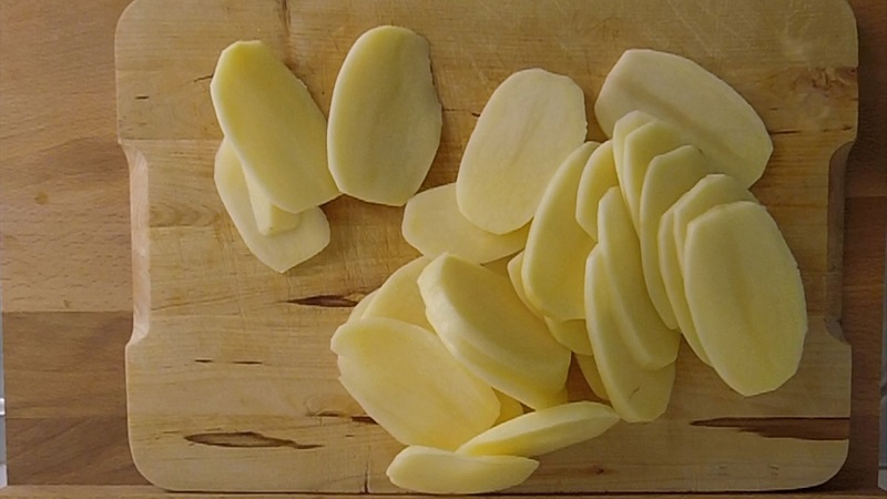 cut thin potato slices for greek moussaka