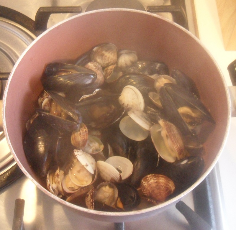 Open mussels and clams for the italian seafood spaghetti
