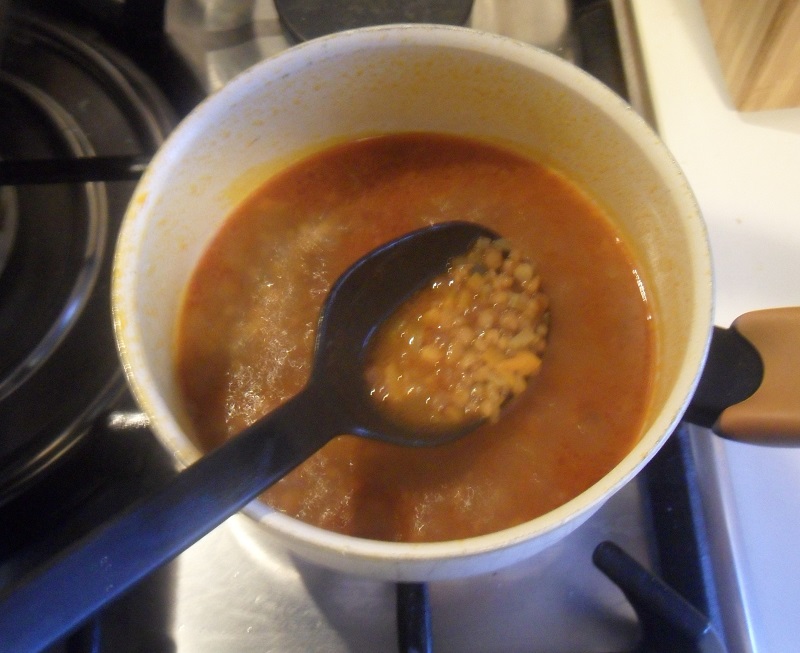 Stew the lentils in tomato puree and vegetable broth
