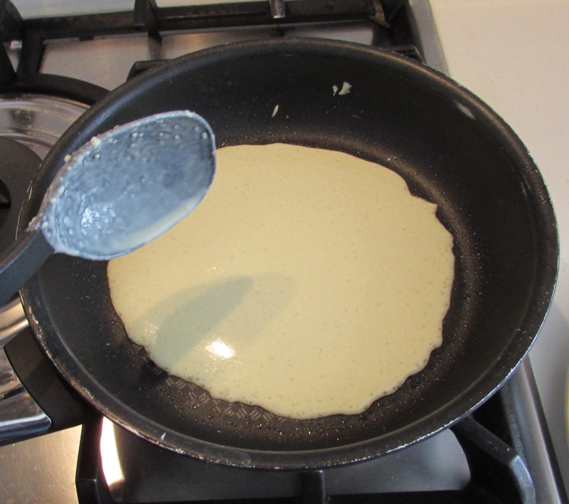 pour a couple of gluten-free crepe dough in the pan