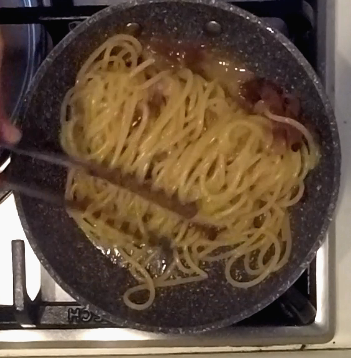 stir spaghetti carbonara with guanciale