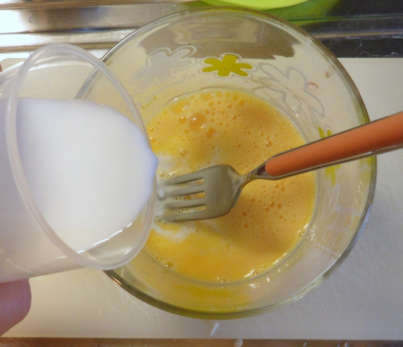 Pour the milk into the beaten egg yolks for the gluten-free pancake batter