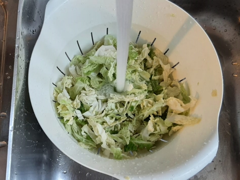 Slice the cabbage into thin strips and rinse it thoroughly.